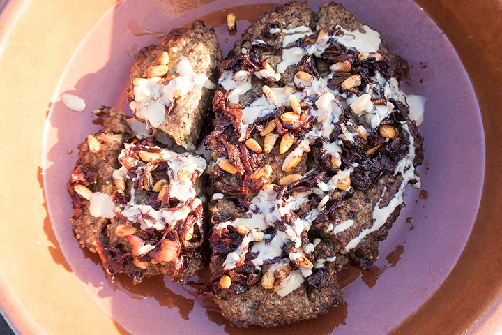 Baked lamb kibbeh with onions, pine nuts and tahini