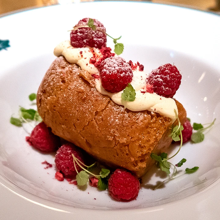 Rum baba with Chantilly cream and raspberries